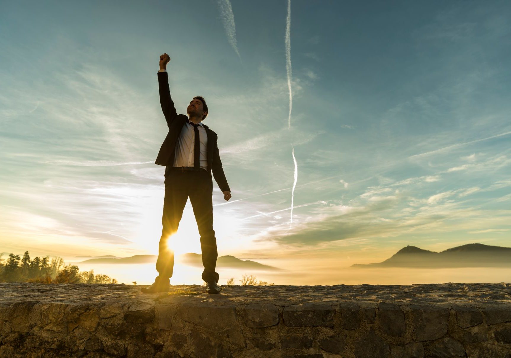 triumphant-businessman-greeting-a-new-day-ESX8JUR